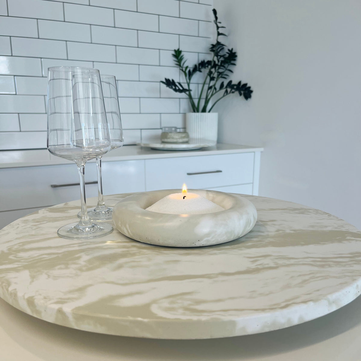 Lennoelia Designs 500 mm concrete Lazy Susan paired with the Rosie Bowl candle in Signature Marble finish for modern table styling.  