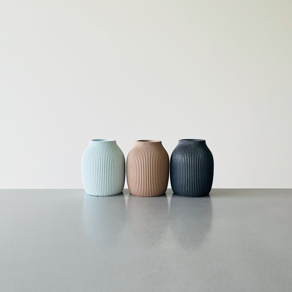 Set of three solid concrete finish Macey Vase. Sea Salt, Moon Shadow and Earth Bound Lennoelia Designs Signature Colours
