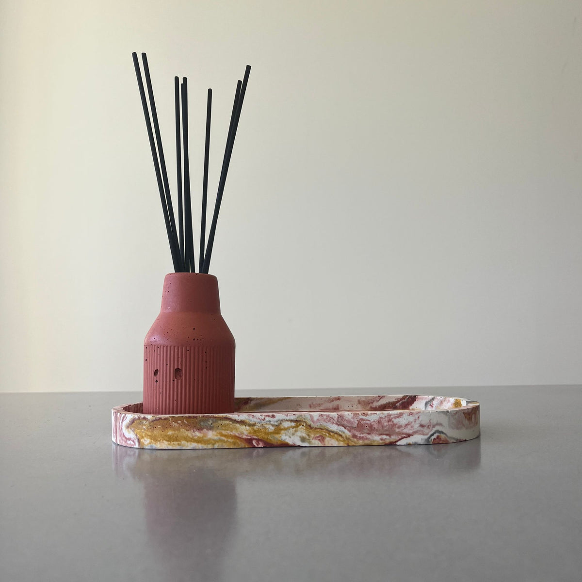 Ritual tray styled with a diffuser vessel and reeds